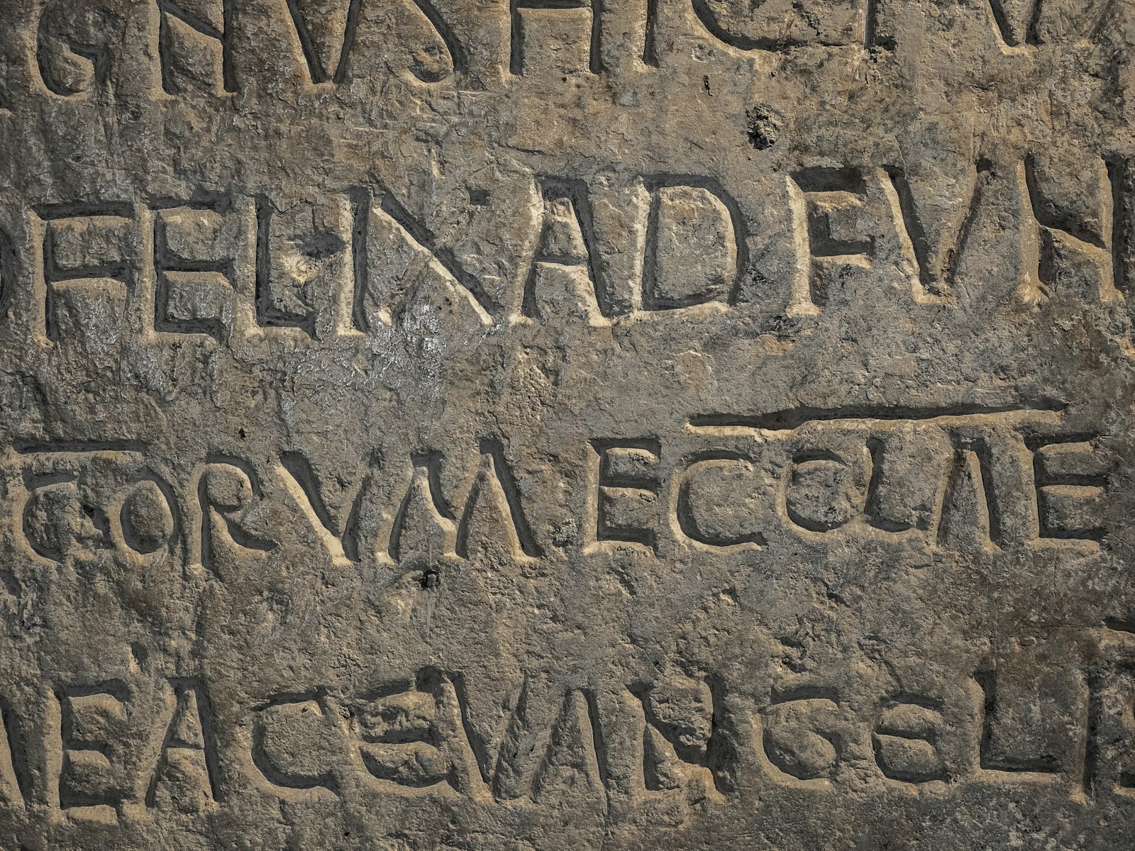 Close-up of ancient stone inscription with latin text.