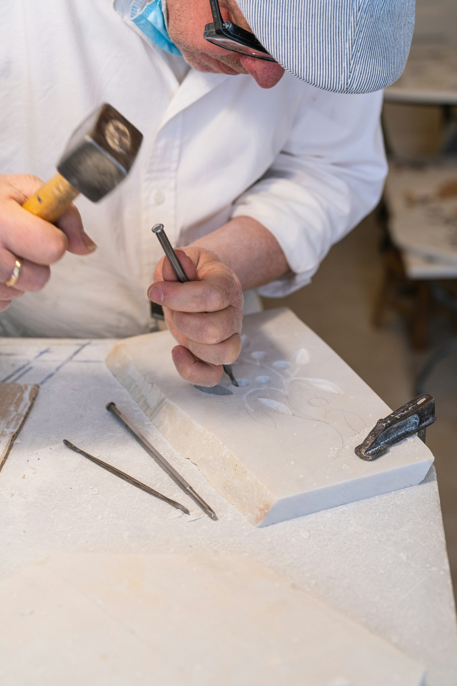 A man in a white shirt and some tools.